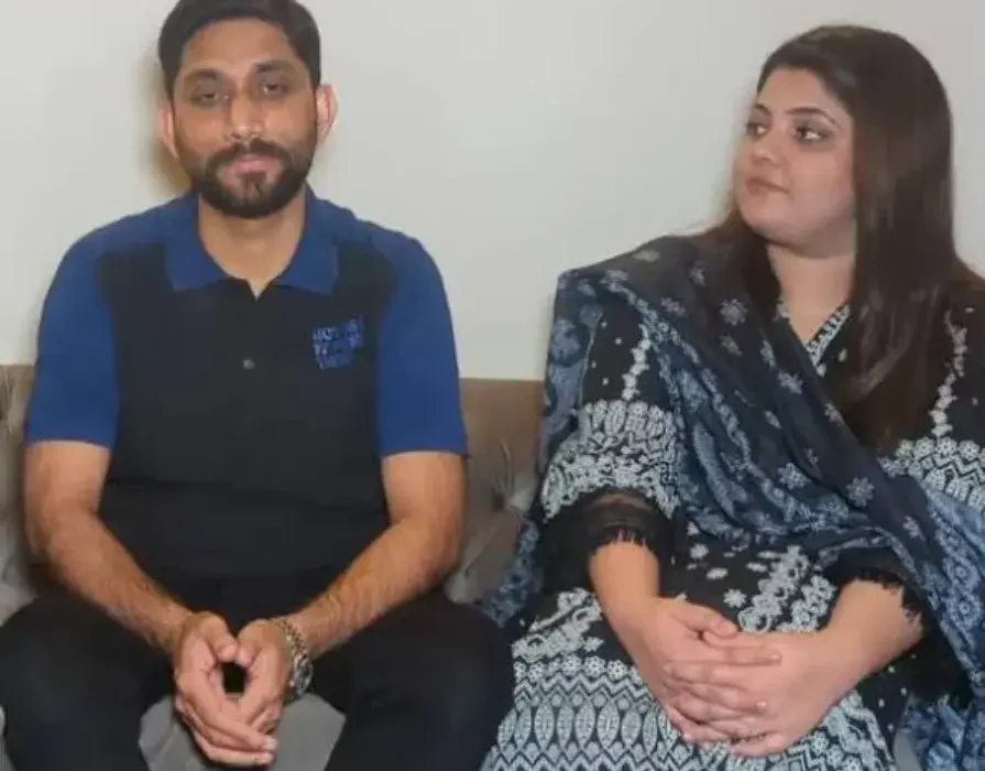 A heartfelt moment showing a Pakistani man holding hands with his recovering wife in a hospital room after donating 60% of his liver, symbolizing love, sacrifice, and hope.