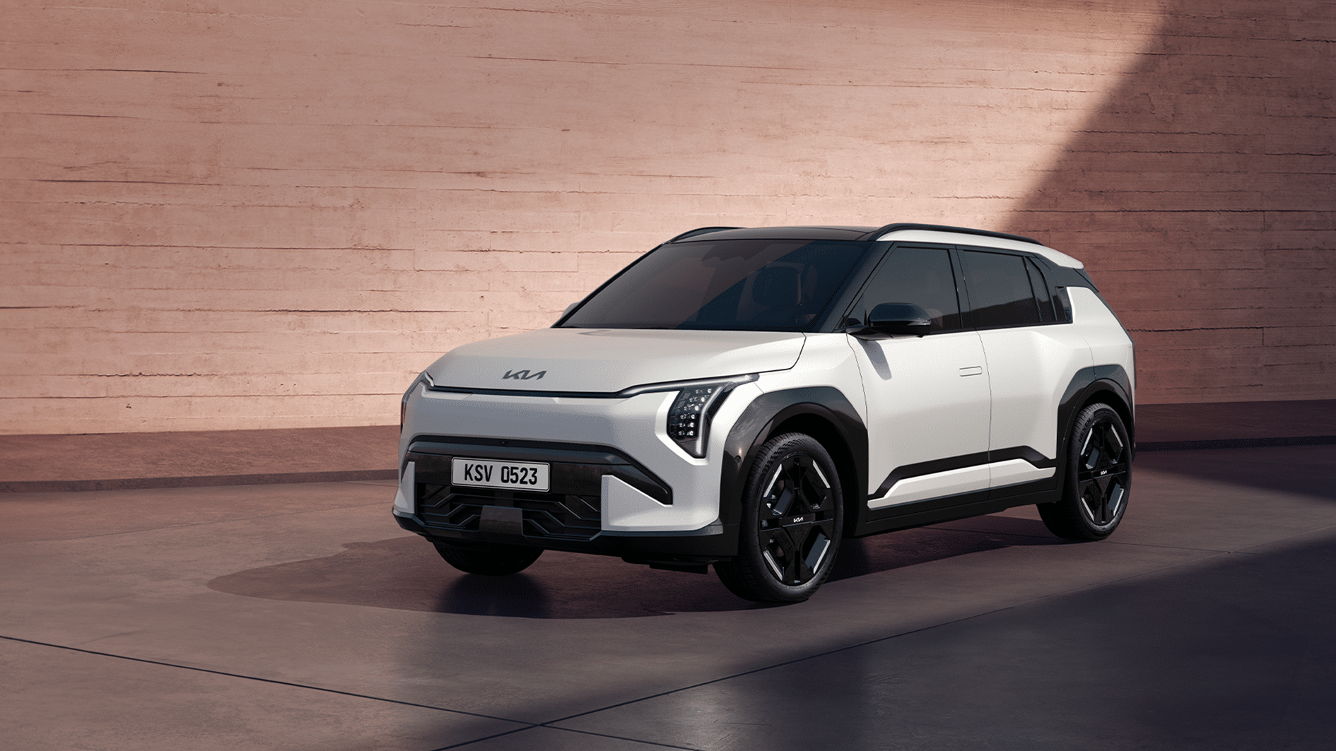 A futuristic Kia EV3 electric SUV on display at the New York Auto Show after winning the 2025 World Car of the Year, showcasing sleek design and innovation