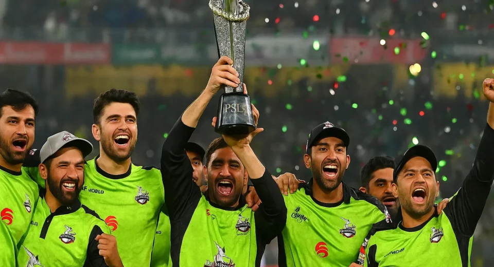 Lahore Qalandars players celebrating with PSL trophy after winning their third Pakistan Super League title in front of a packed stadium
