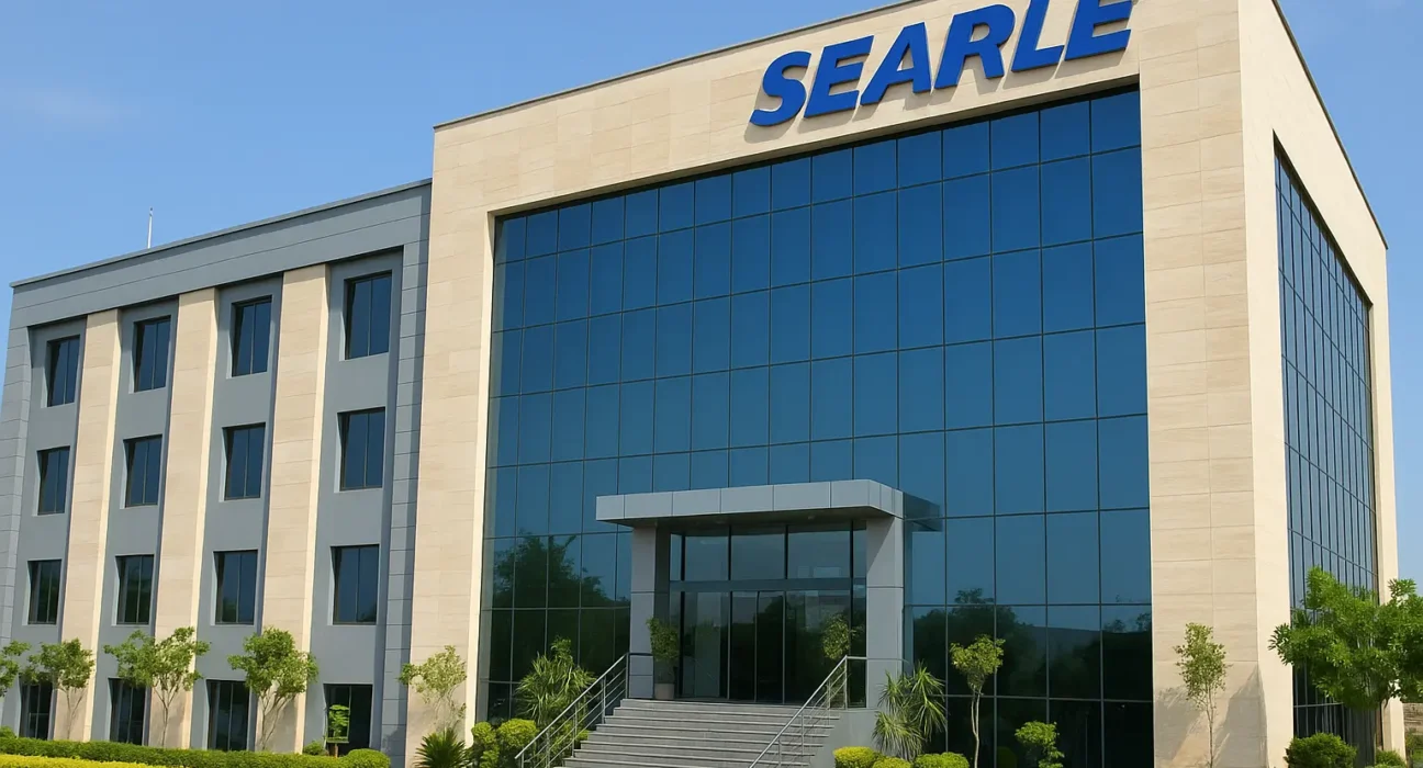 Modern Searle Pakistan headquarters building with glass facade and landscaped entrance under clear blue sky