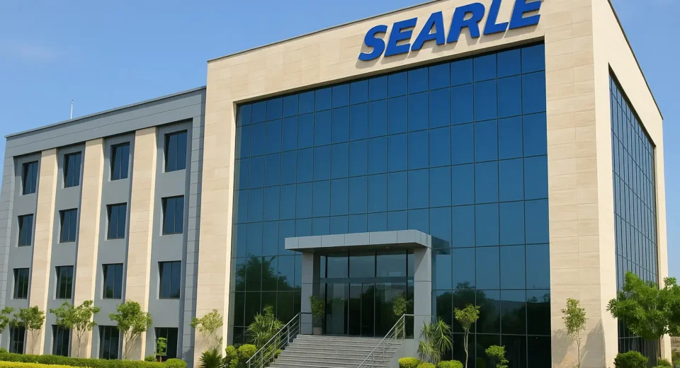 Modern Searle Pakistan headquarters building with glass facade and landscaped entrance under clear blue sky